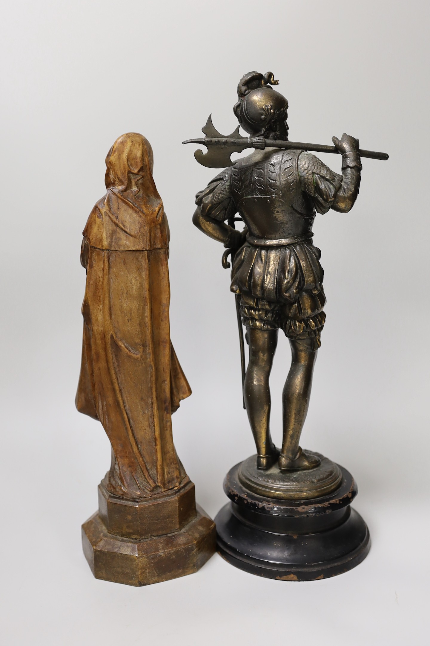 A 19th century carved wood figure of the ‘Virgin of Nuremberg’ together with a spelter figure of a guard. Tallest 38cm